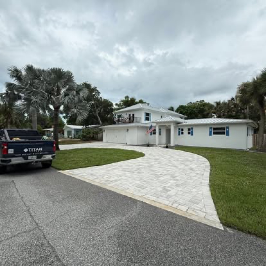 Paver driveway wrapping to a two-car garage in Melbourne