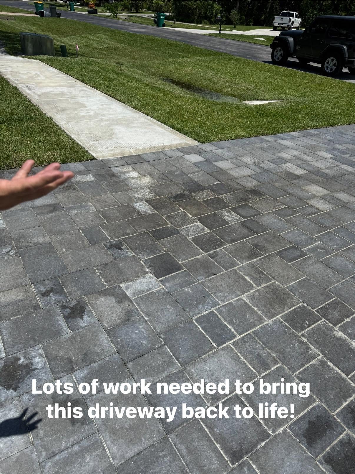 Tired stained paver driveway before restoration